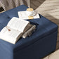 Blue upholstered storage ottoman bench with flip-top lid and tufted details