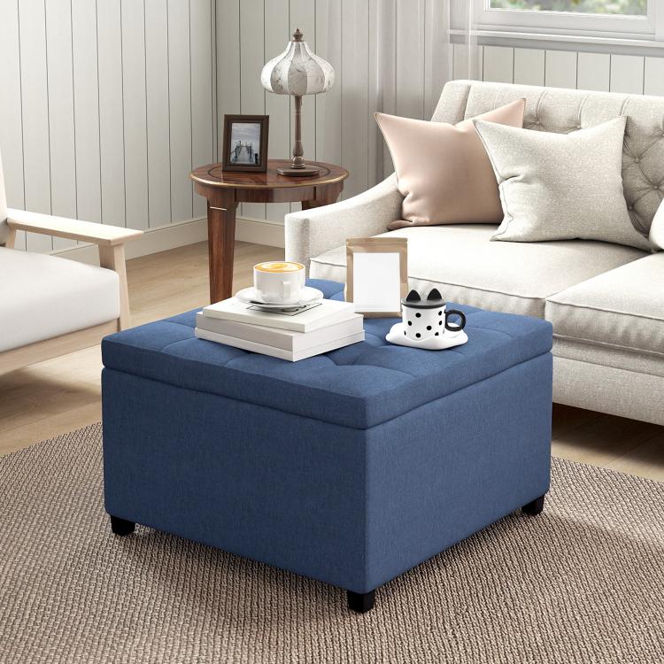 Blue flip-top storage ottoman placed next to a living room sofa