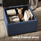 Blue upholstered storage ottoman with flip-top open, showing inner storage