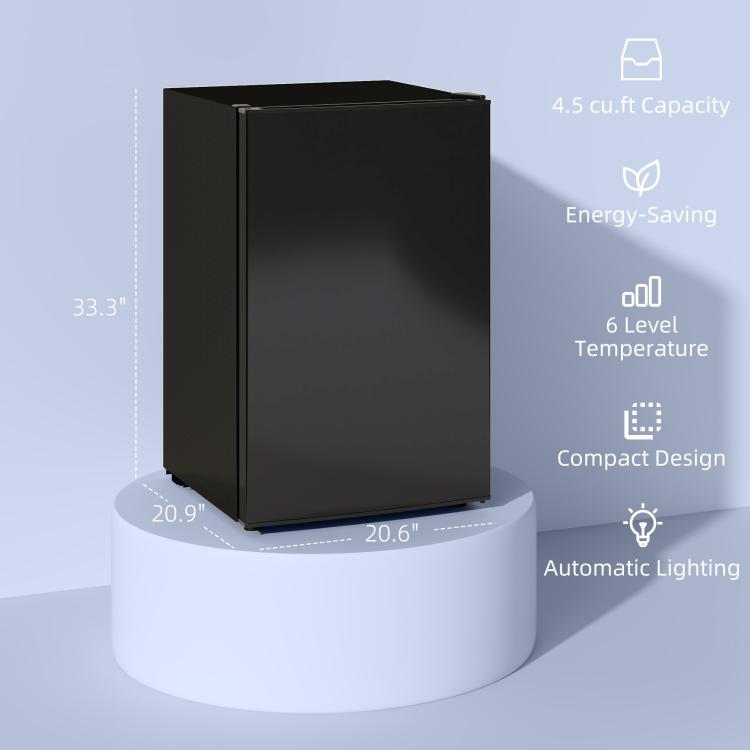 Black mini single-door refrigerator with freezer, closed on a small round base.