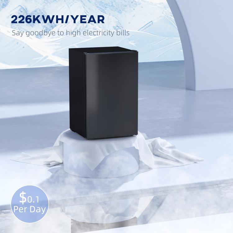 Black mini single-door refrigerator standing on protective insulation, compact size.