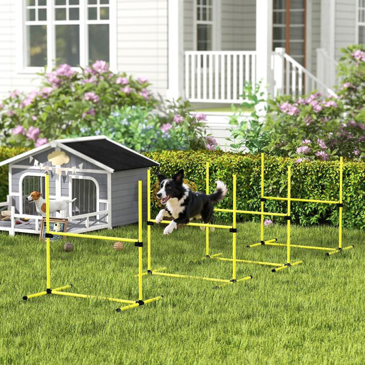 Yellow dog agility jump course with adjustable bars and black support clamps in yard