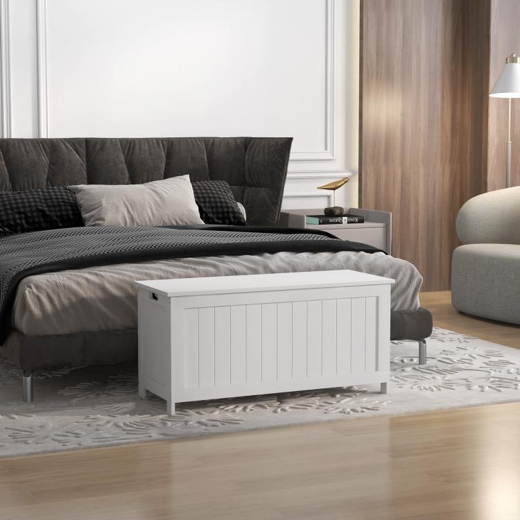 White wooden storage bench trunk with lid closed and slatted front panels