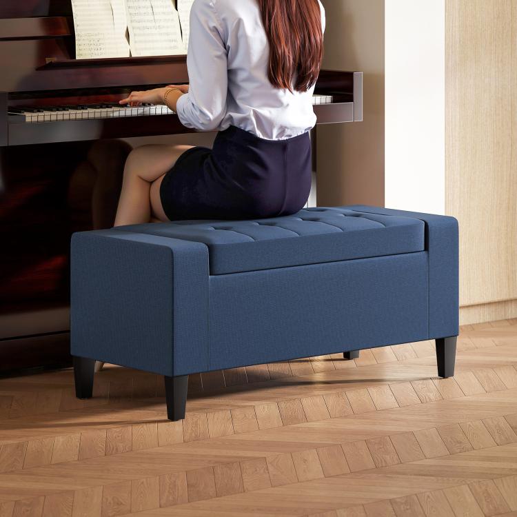 Dark blue button-tufted lift-top storage ottoman bench with padded arms and legs