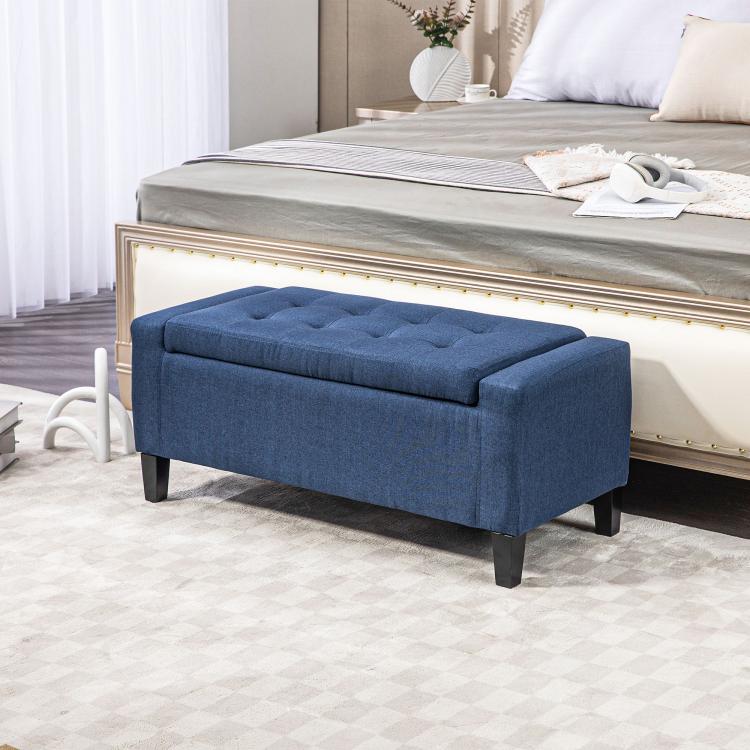 Dark blue lift-top storage ottoman bench with tufted cushion top and dark legs