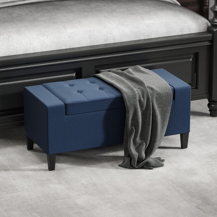 Dark blue lift-top storage ottoman bench with open lid and dark wooden legs
