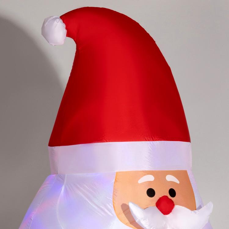 Inflatable red Santa yard display with white beard and pink-lit face