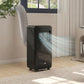 Black portable air conditioner standing indoors with attached exhaust hose
