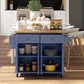 Navy rolling kitchen island cart with open shelves and drawers holding cookware and jars