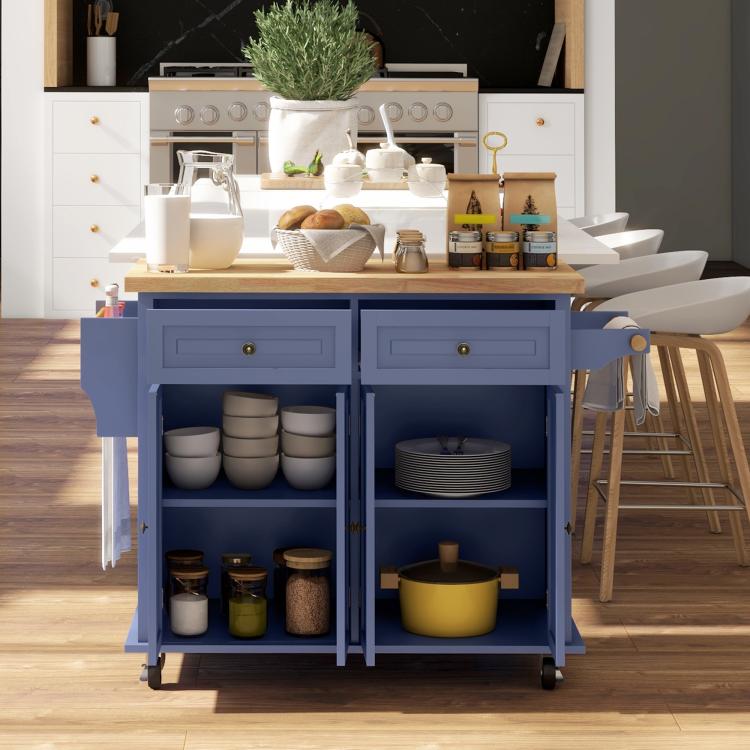Navy rolling kitchen island cart with open shelves and drawers holding cookware and jars