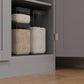 Distressed white kitchen pantry cabinet with open shelves and door