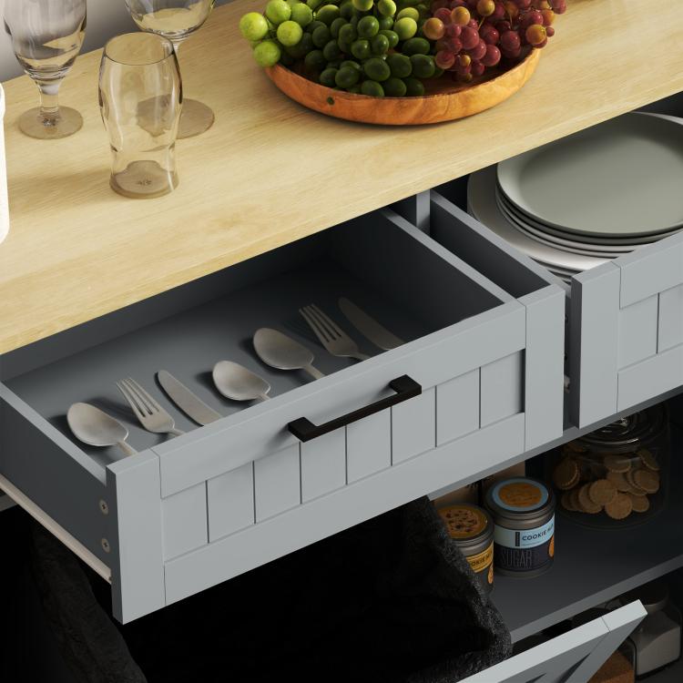 Gray kitchen cabinet with open drawers and tilt-out hidden trash bin, interior shelves visible