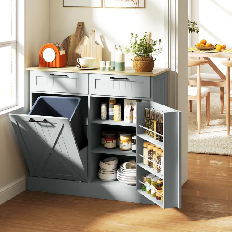 Gray farmhouse kitchen cabinet with open side shelves and tilt-out hidden trash can compartment.