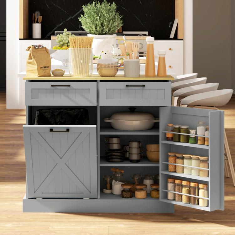 Gray hidden-trash kitchen cabinet with barn-style door, open shelves for jars and canisters.
