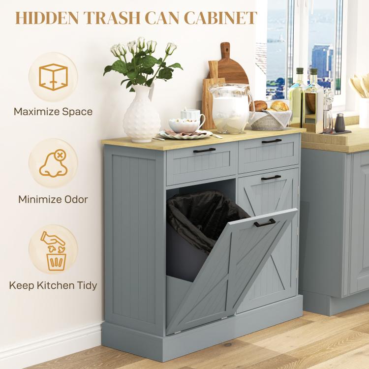 Gray hidden trash can cabinet with farmhouse doors and tilt-out bin, drawers closed, storage inside.