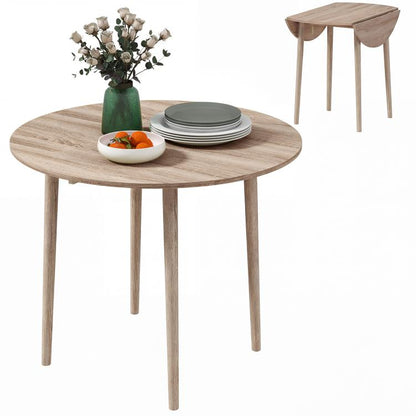 Round drop-leaf dining table in light oak tone with four wooden legs