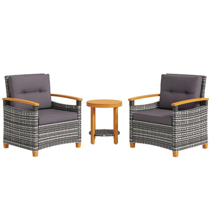 Outdoor bistro set: two gray cushioned wicker armchairs and round wood side table