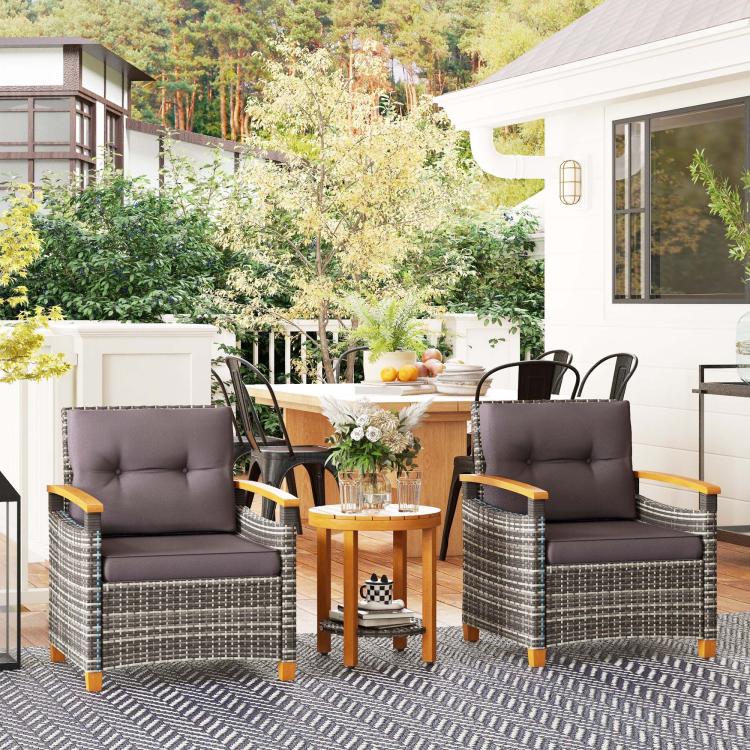 Outdoor bistro set: two gray cushioned wicker armchairs with round wood table