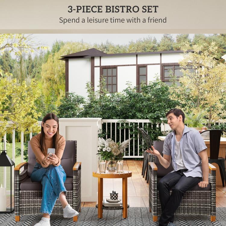 Outdoor bistro set with two gray cushioned wicker chairs and round wood table