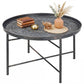 Round coffee table with hammered tray top and dark metal legs, pewter-style finish