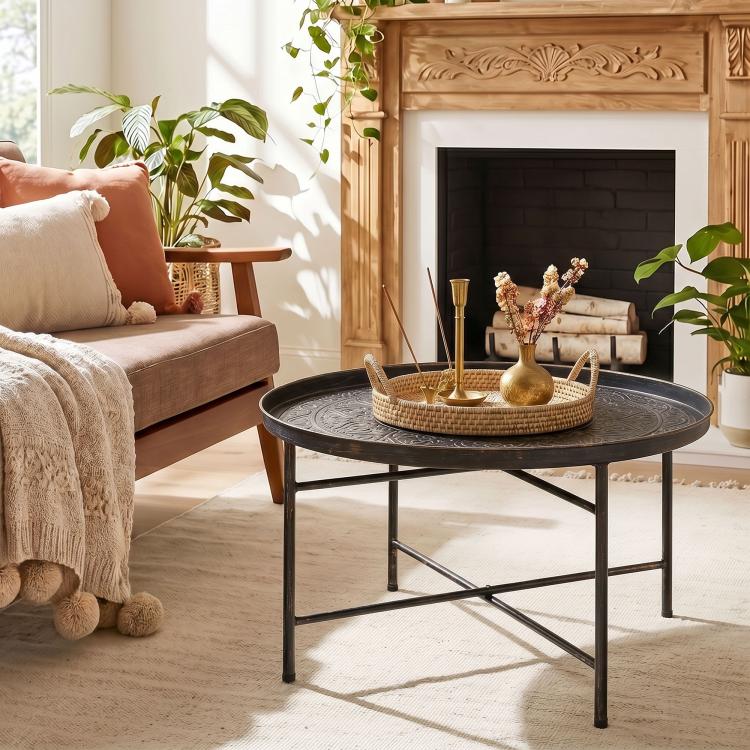 Round coffee table with hammered metal tray top and dark metal frame for living room