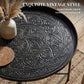 Hammered floral pattern tray top on round coffee table with brushed metal finish