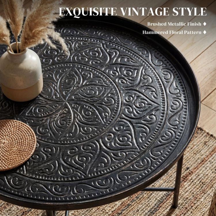 Hammered floral pattern tray top on round coffee table with brushed metal finish