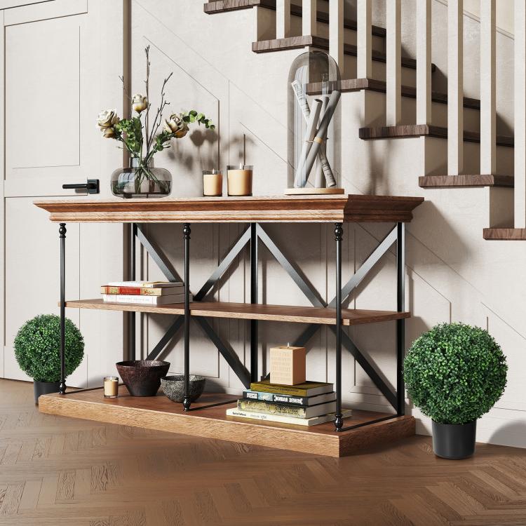 Artificial ball topiary trees with black pots on a wooden console table.