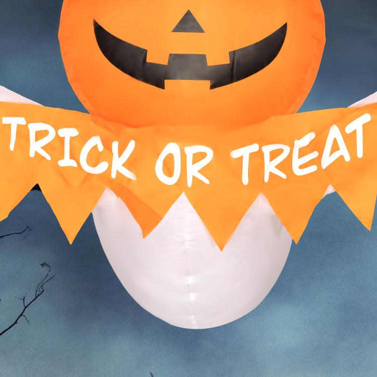 Close-up inflatable Halloween ghost: orange pumpkin face and large “Trick or Treat” banner