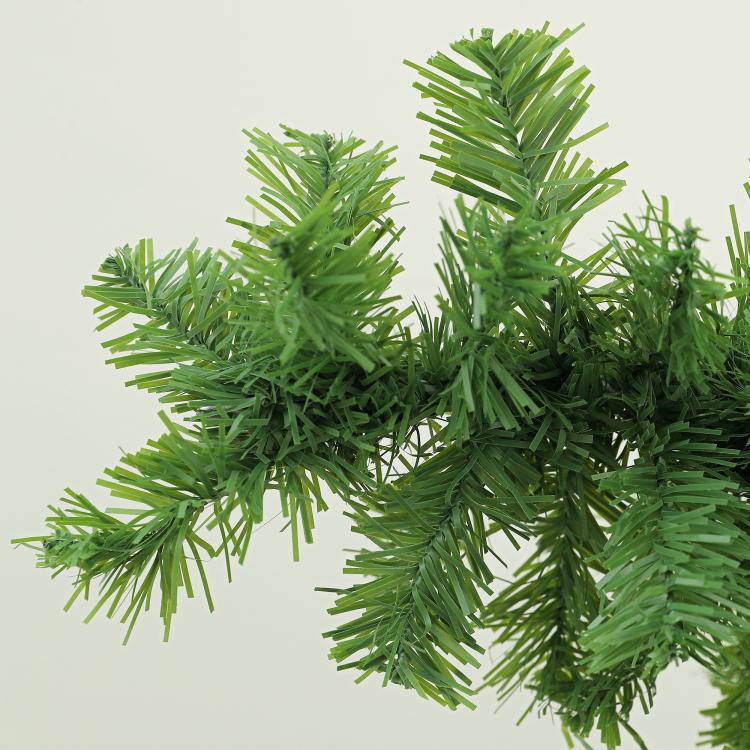 Green bendable pencil Christmas tree with dense branch tips, close-up view