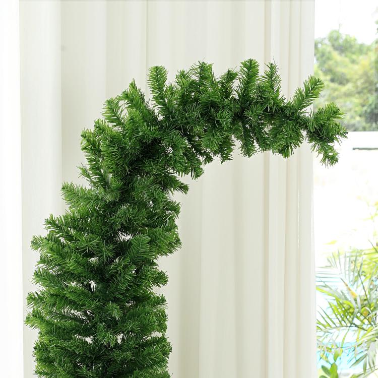 Close-up of green pencil artificial Christmas tree branches and dense needle coverage