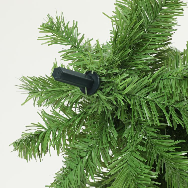 Green artificial Christmas tree branch tips with black bend connector close-up