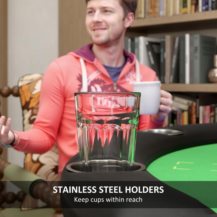 Poker table cup holder on black rim beside green felt surface
