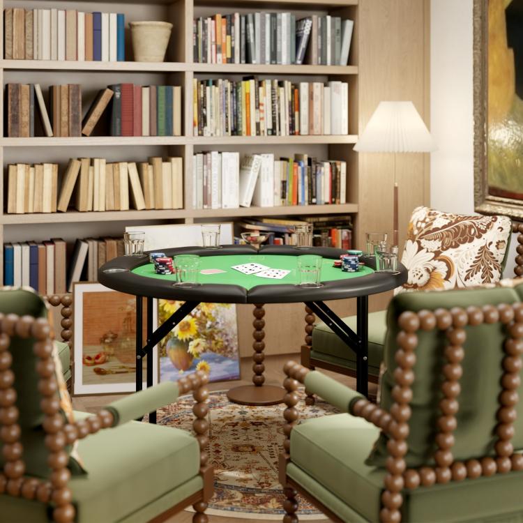 Round poker table with green felt top and black metal legs in living room