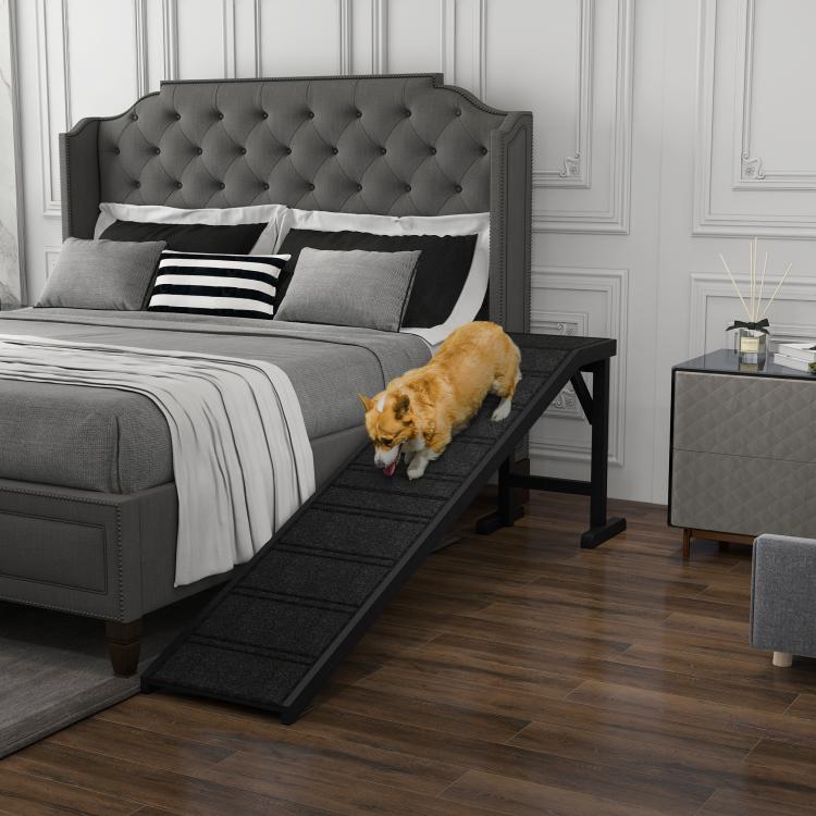 Black pet ramp with non-slip carpet and top platform, tan dog walking on it indoors