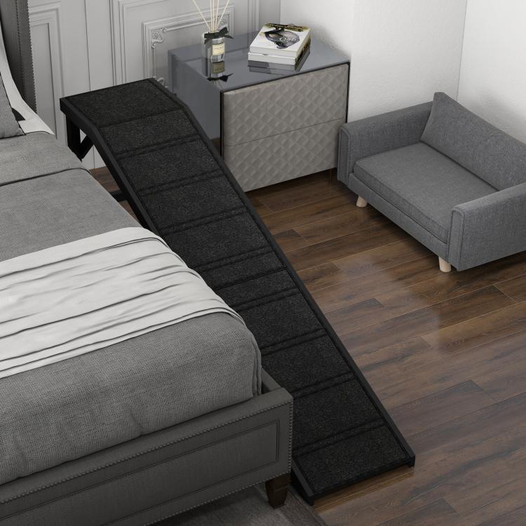 Black dog ramp on floor carpet with anti-slip tread, used beside a sofa