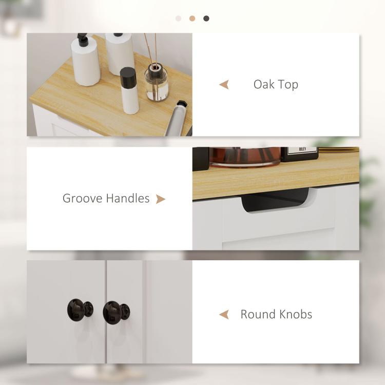 White bathroom cabinet details: oak top, groove handles on drawers, round door knobs.