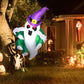 Inflatable Halloween ghost with glowing LED face, purple hat and green outfit outdoors