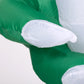 Close-up of inflatable ghost white body and arm over green fabric, Halloween decor