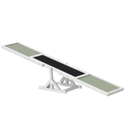 White wooden dog agility seesaw with green and black textured panels, raised center