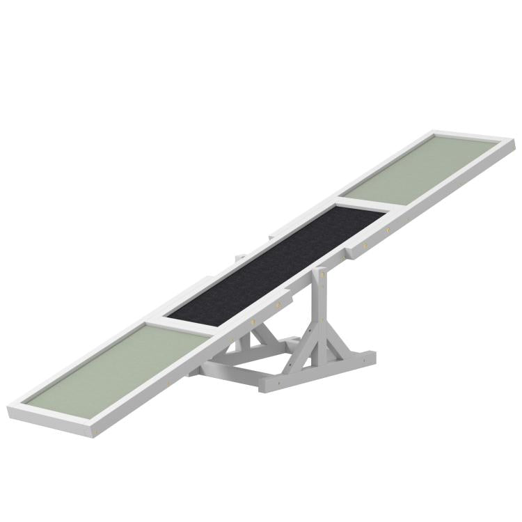 Angled view of white wooden dog agility seesaw with two green ramps and black strip
