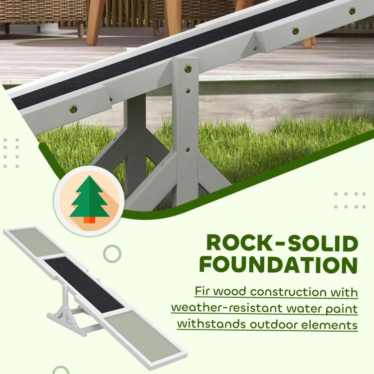 White wooden dog agility seesaw close-up of side supports and green ramp panel