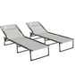 Set of two reclining chaise lounge chairs with light cushions and bungee seat mesh on black frames