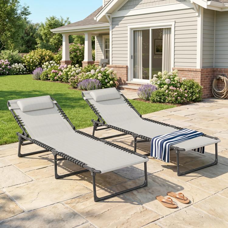 Two folding chaise lounge chairs with gray cushion fabric and black bungee seating