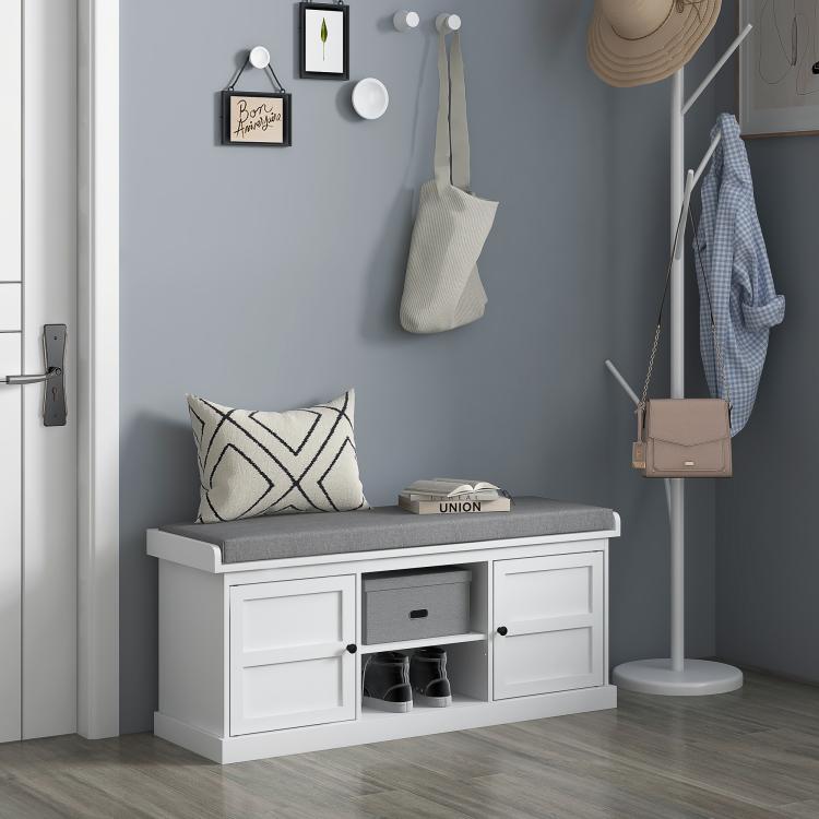 White shoe bench with gray upholstered seat and open center cubby for shoes