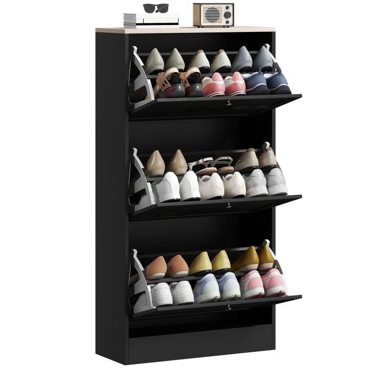 Black shoe storage cabinet with three flip compartments holding multiple pairs of shoes