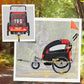 Black and red bike trailer viewed from side with mesh windows and dual wheels
