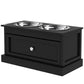 Black elevated dog feeding station with two stainless steel bowls and drawer front