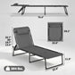 Gray chaise lounge chair with padded headrest, black frame, and bungee-style straps