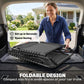 Gray folding chaise lounge chair partially unfolded in an open vehicle trunk